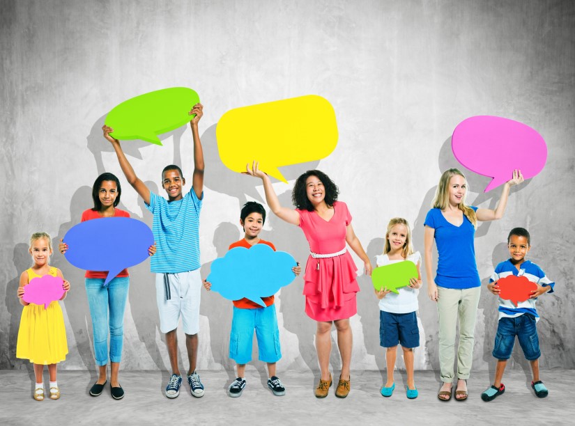 Children and teens holding colourful speech bubbles