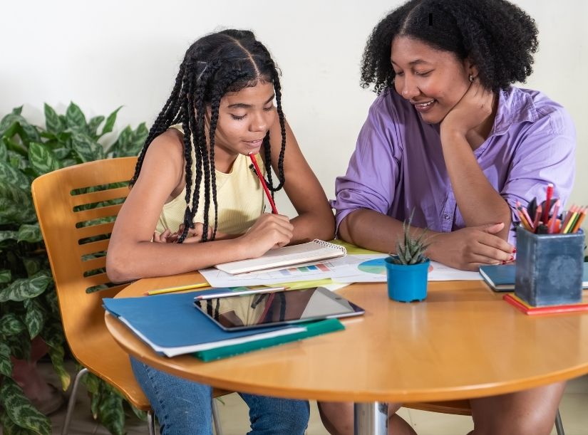 Woman helping child with homework