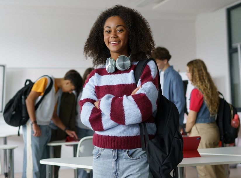 Teen at school with arms crossed